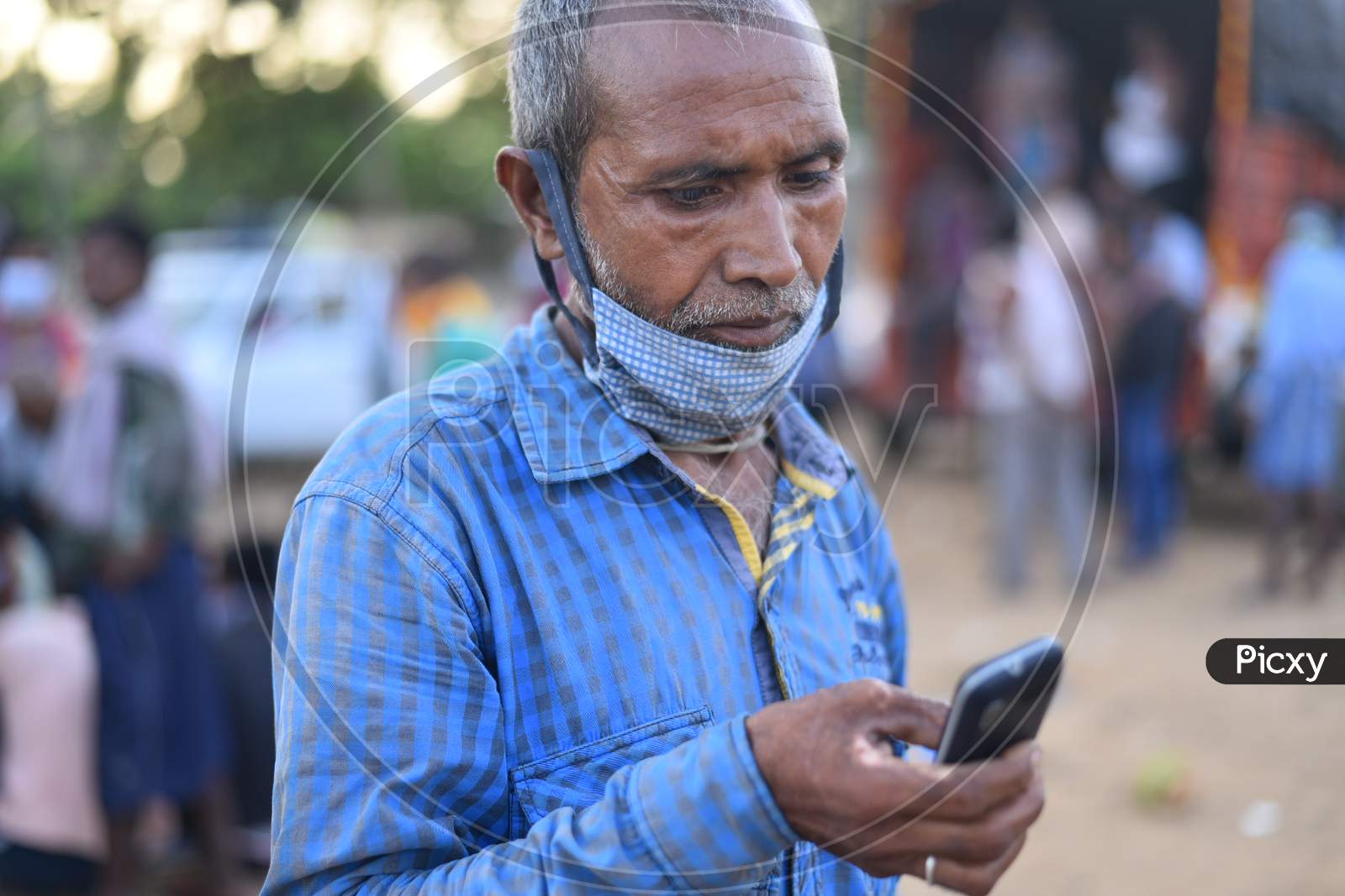 a migrant worker from Bihar talks with his family over a phone as he waits for clearance to move during an extended Lockdown amid coronavirus fears, May 16,2020