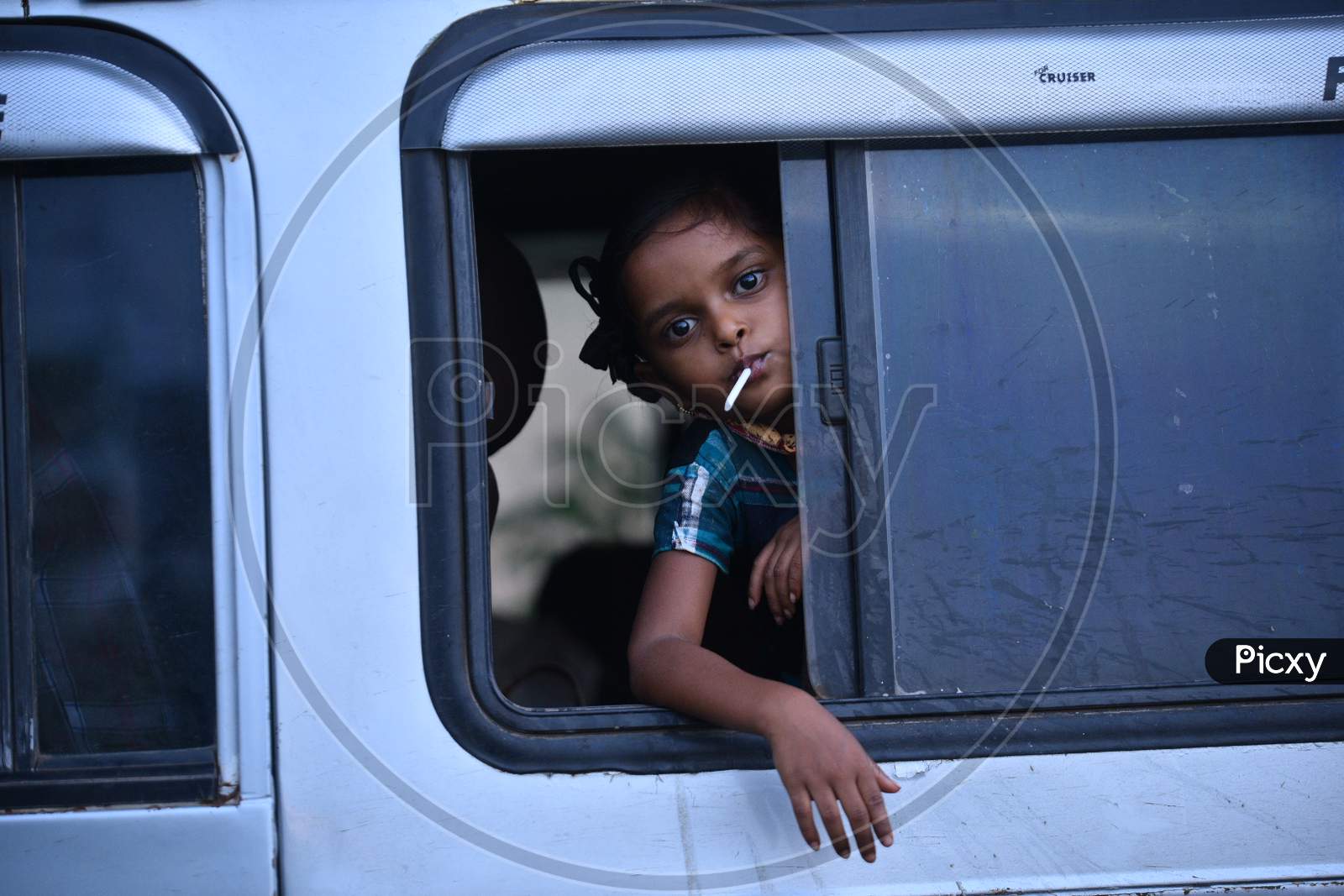 Girl Child Of a Migrant Worker Waiting in a Vehicle At  Andhra Pradesh - Telangana Border Waiting For  Clearance During Nationwide Lockdown Amidst Coronavirus Or COVID-19 Pandemic In Aswaraopeta, Telangana