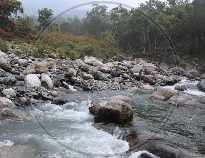 Beautiful View Of Flowing Water Between Stones In Uttarakhand, India