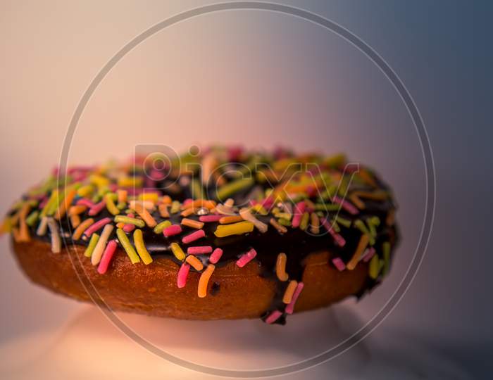Assorted Donuts With Dark Chocolate Frosted And Sprinkles On It