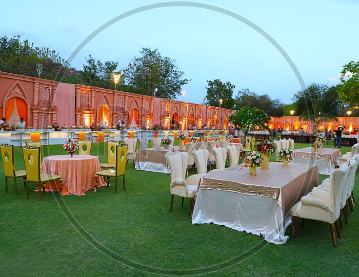 Jodhpur, Rajasthan, India - May 18Th, 2018: Luxurious Long Dinner Tables And Chairs, Rich Decorated With Flowers In The Garden , Indian Wedding Arrangement Setup - Image