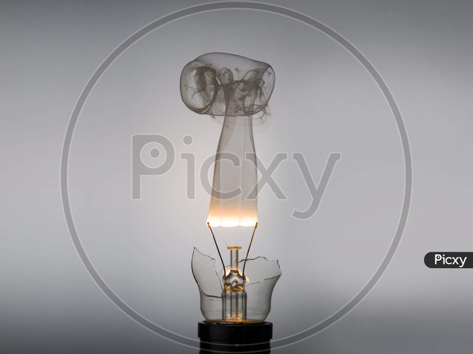 Broken Incandescent light bulb with fire and smoke