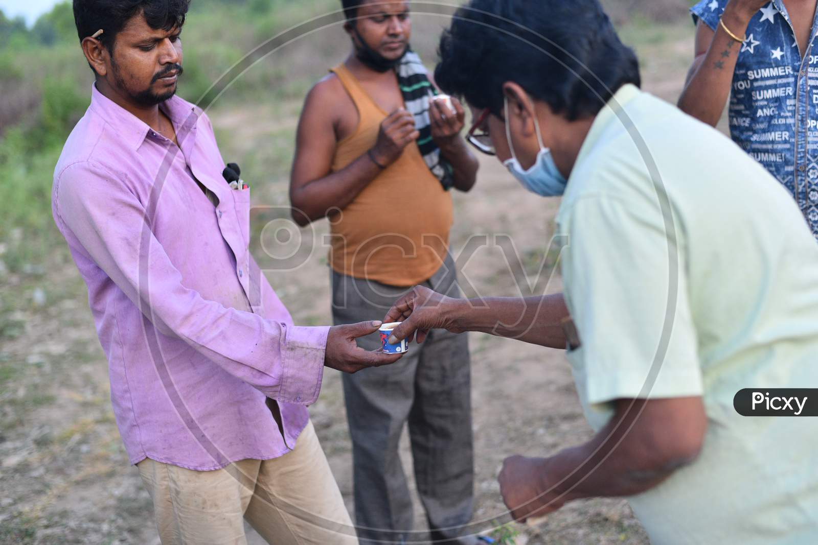 migrants buy tea from a vendor
