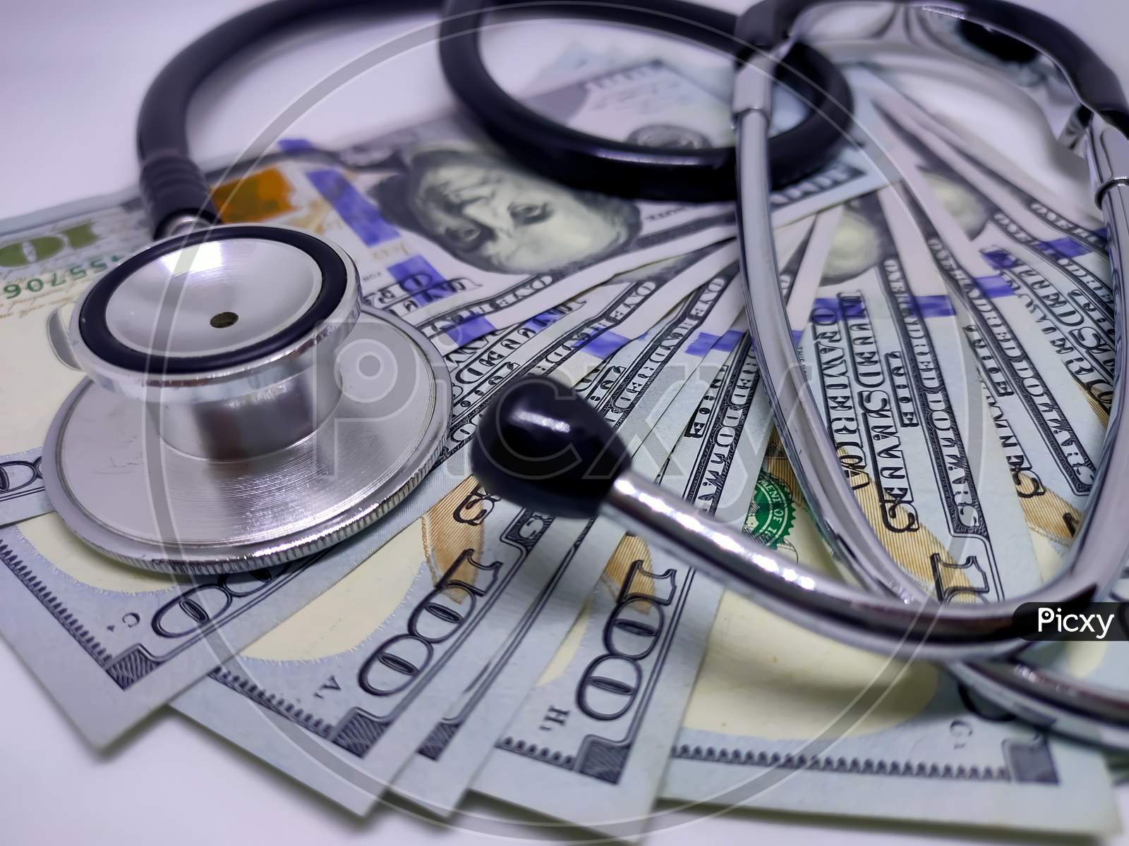 Stethoscope On The Background Of Us Dollar Bill. The Concept Of Paid Medicine. Medical Cost. Healthcare Payment System.