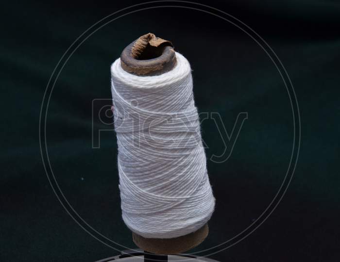 White Thread Roll with Black Background View