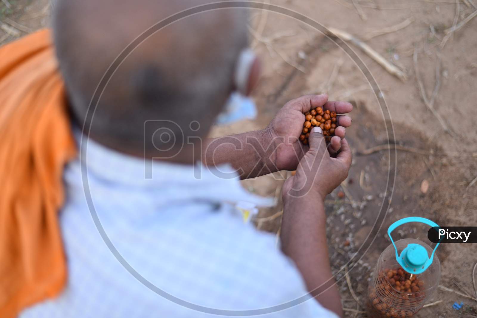 A migrant worker eats Black Chick Peas or Black Gram as breakfast as he waits for clearance to move during an extended Lockdown amid coronavirus fears, May 16,2020