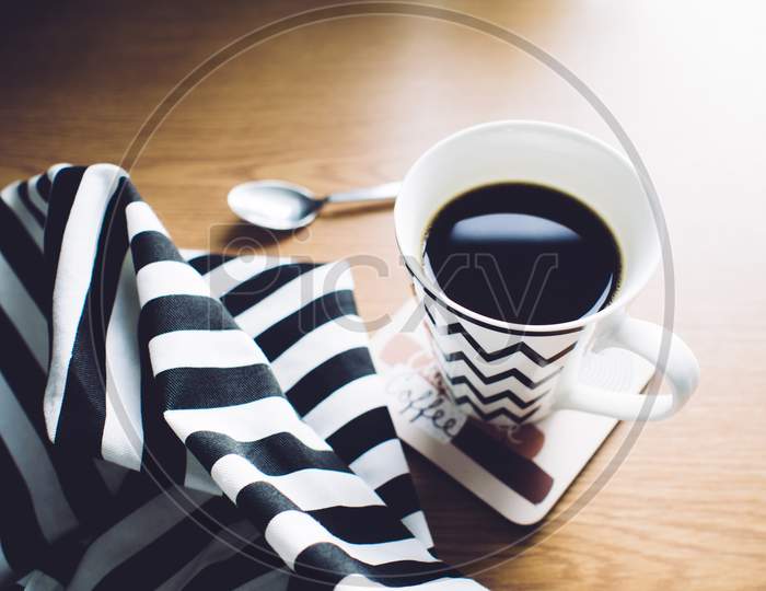 Hot Black Coffee in Coffee cup on wooden table