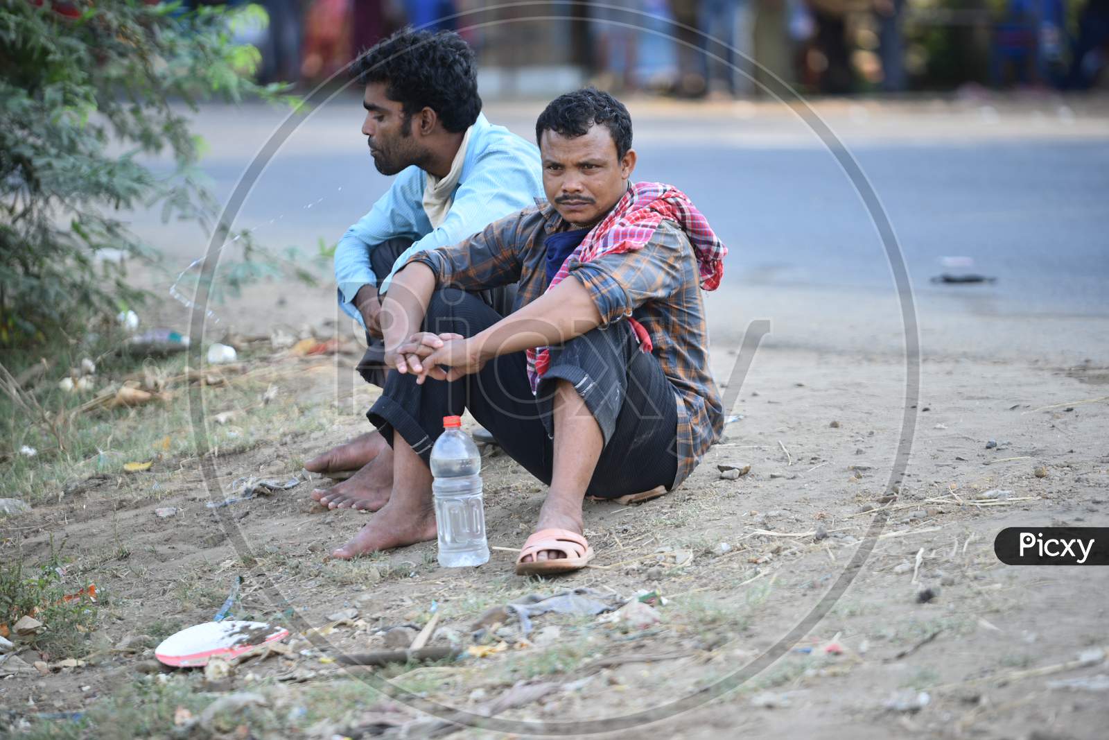 Migrant workers from West Bengal and Bihar wait for permission to cross Telangana State at a Checkpost in Aswaropeta during an extended lockdown amid coronavirus fears, May 16,2020.
