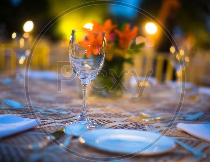 Royal Dining Setup With Beautiful Plates And Glasses On The Table, Destination Wedding Dinner - Image