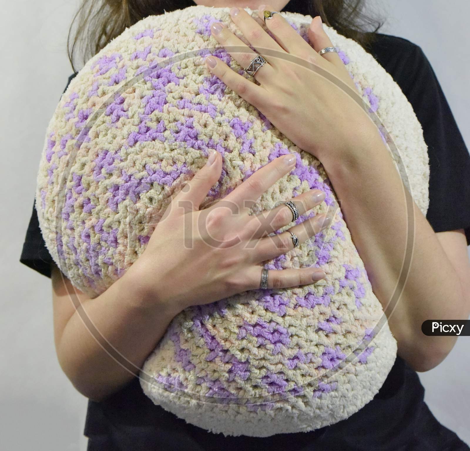 Female Hands Hug A Knitted Pillow