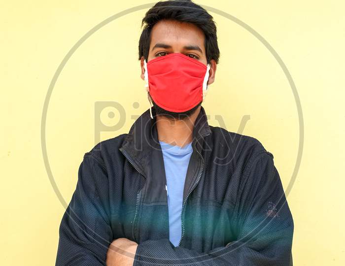 photo of a young indian guy wearing a face mask to protect against the coronavirus during lockdown with selective focus, selective focus on subject, background blur