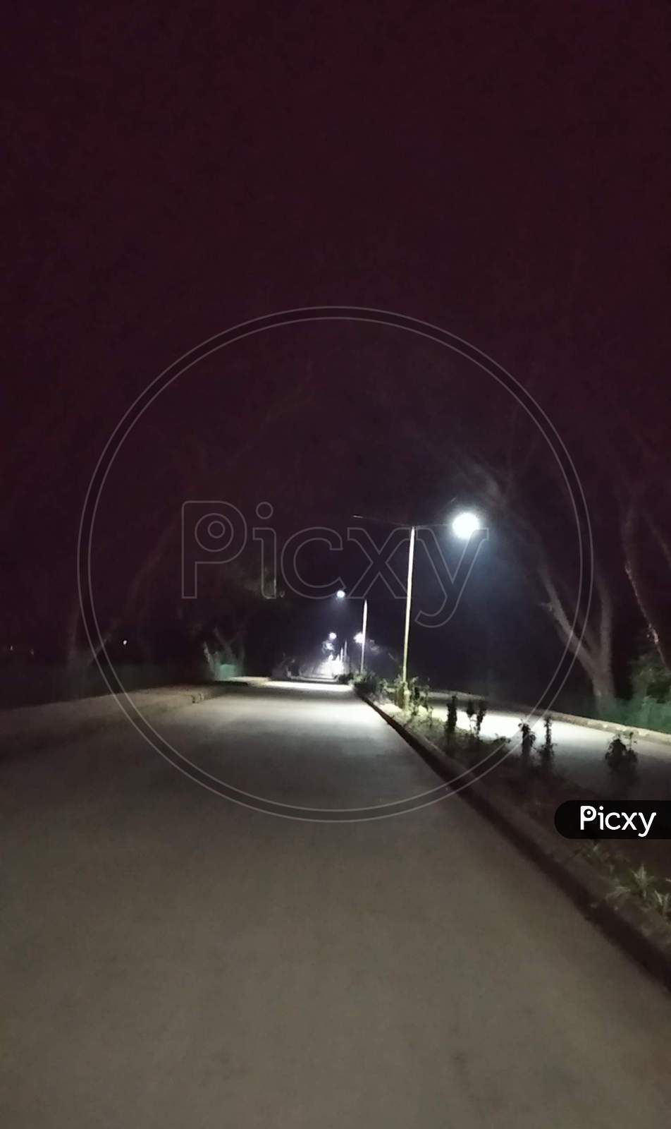 Night empty road with streetlights