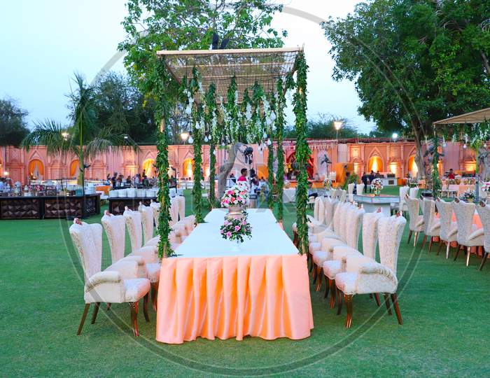 Luxurious Dinner Table And Chairs, Rich Decorated With Flower Pots, Indian Wedding Setup - Image