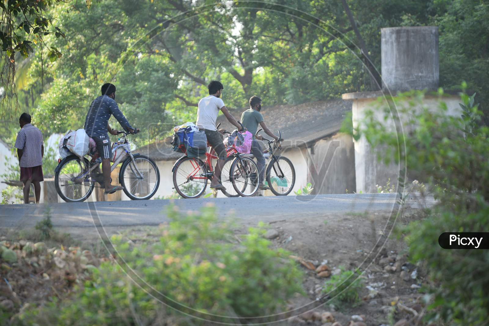 Migrant Workers Travelling By Bicycles To Cross Telangana-Andhra Pradesh Border in West Godavari During Nationwide Lockdown Amidst Coronavirus Or COVID-19 Pandemic In Aswaraopeta, Telangana