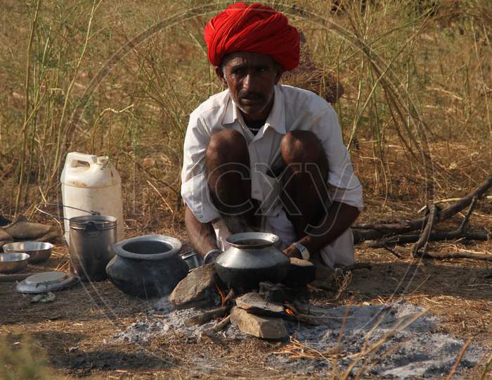 A Camel Trader Cooking Food At Pushkar Camel Fair, Pushkar
