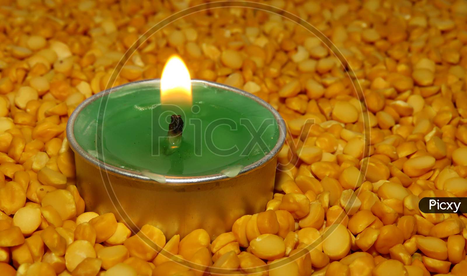 burning candles Split pea ,Candles on Split pea background,Green candles on the seeds,Burning Candles.