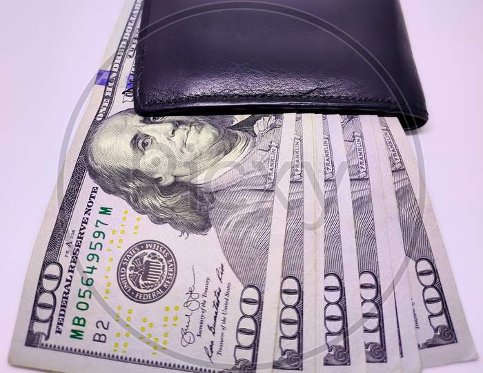 Black Wallet Full Of 100 Dollar Bills.