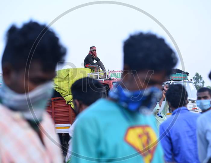 A migrant worker sits on a lorry as he waits for Clearance permission to cross the TS-AP border at Aswaraopeta,Telangana,May 16,2020