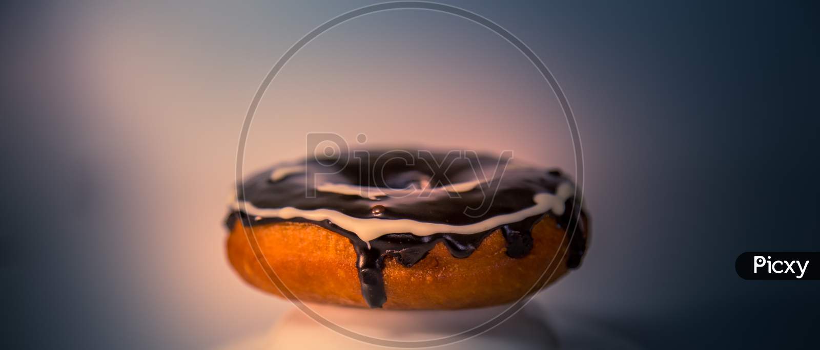 Assorted Donuts With Dark Chocolate Frosted And White Design Chocolate On It