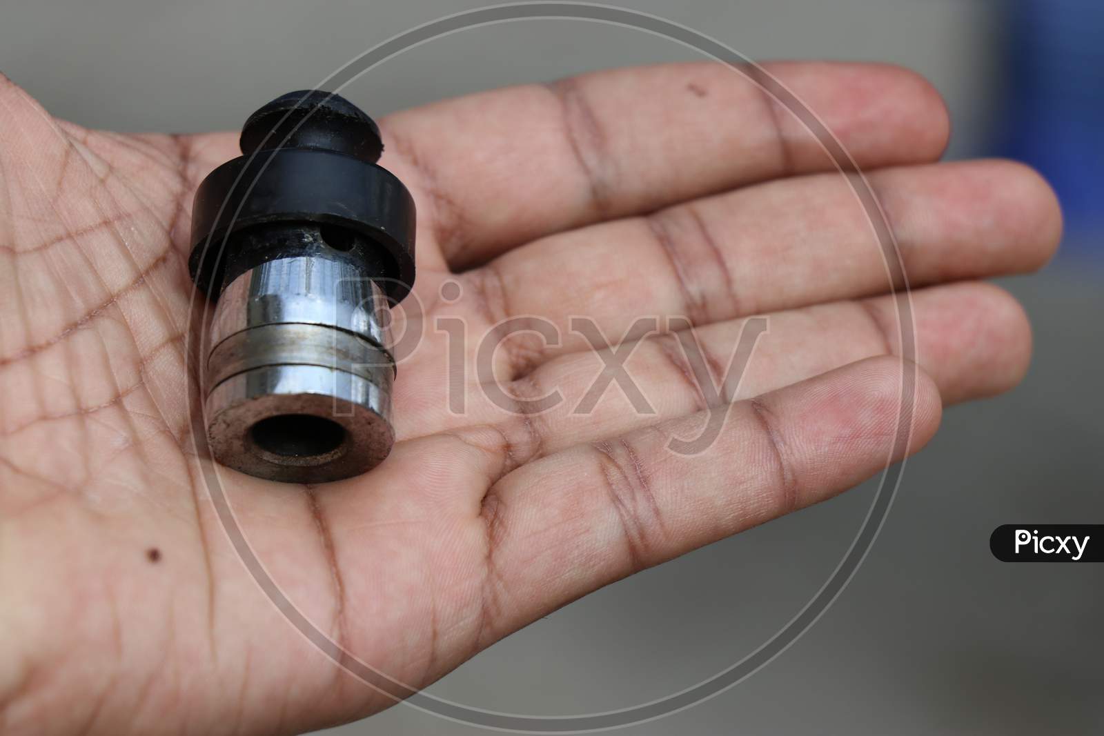 Pressure Cooker Whistle Held In Hand