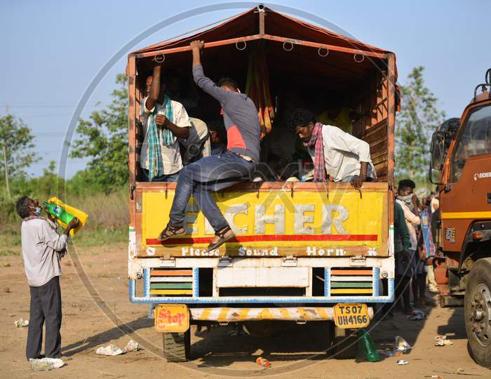 migrant workers board a van