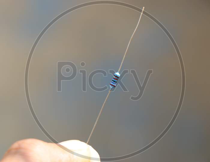 Resistor With Long Pin Held In Hand