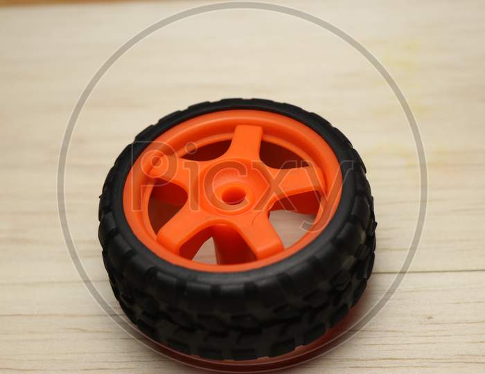 Wheel Of Radio Controlled Car On A Wooden Background