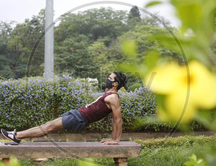 A man exercises on a park bench in Cubbon Park after the state eased lockdown norms during the nationwide lockdown to prevent the spread of coronavirus (COVID-19) in Bangalore, India.