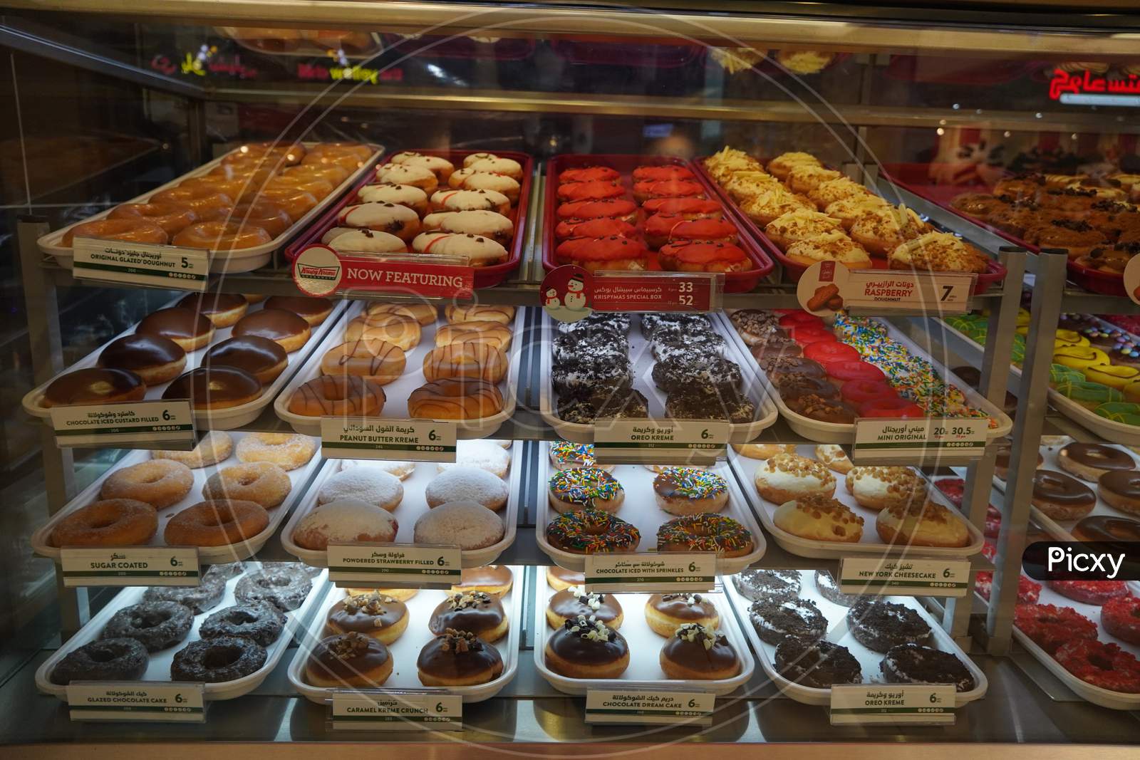 Variety Of Delicious Donut In Showcase On Display At Bakery Cake Shop Krispy Kreme. Various Donuts Type On Shelf In Bakery Shop. Selection Of Sweets. - Dubai Uae December 2019