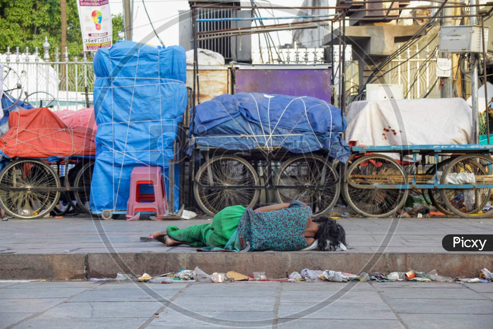 Homeless girl sleeping on footpath