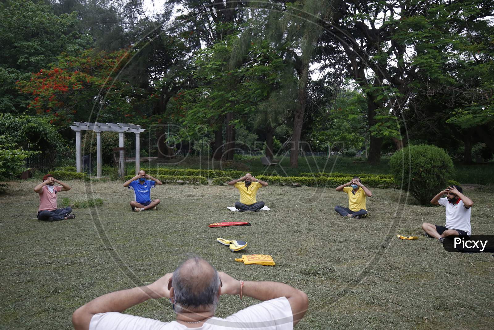 Men perform yoga in Cubbon Park after the state eased lockdown norms during the nationwide lockdown to prevent the spread of coronavirus (COVID-19) in Bangalore, India.
