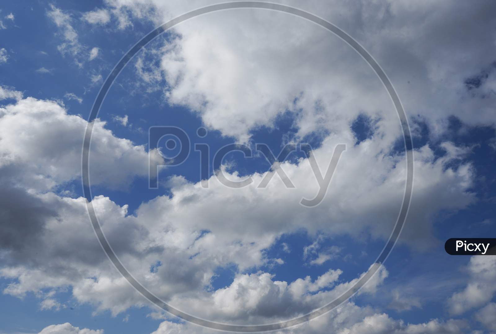 White Clouds Spread All Over The Blue Sky Creating A Contrast And An Abstract Pattern