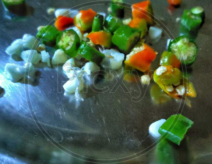 Green chilly and  Garlic after  cutting in a steel plate