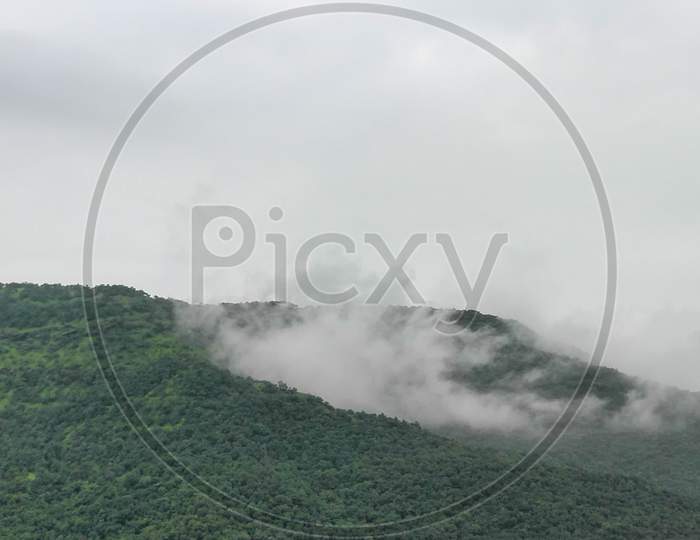 Green mountains with fog