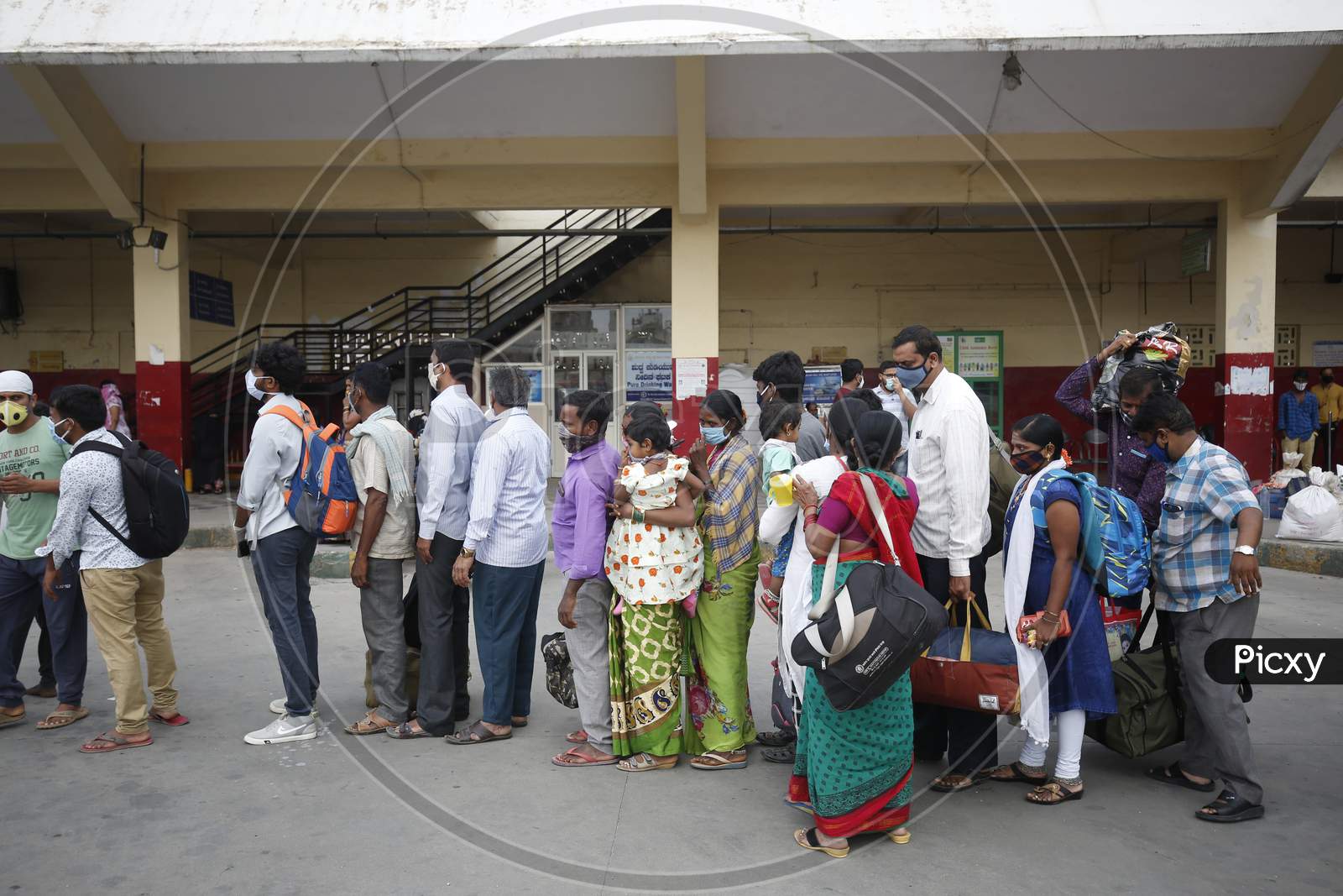 People wait in queue to board a public transport bus after the state eased lockdown norms during the nationwide lockdown to prevent the spread of coronavirus (COVID-19) in Bangalore, India.