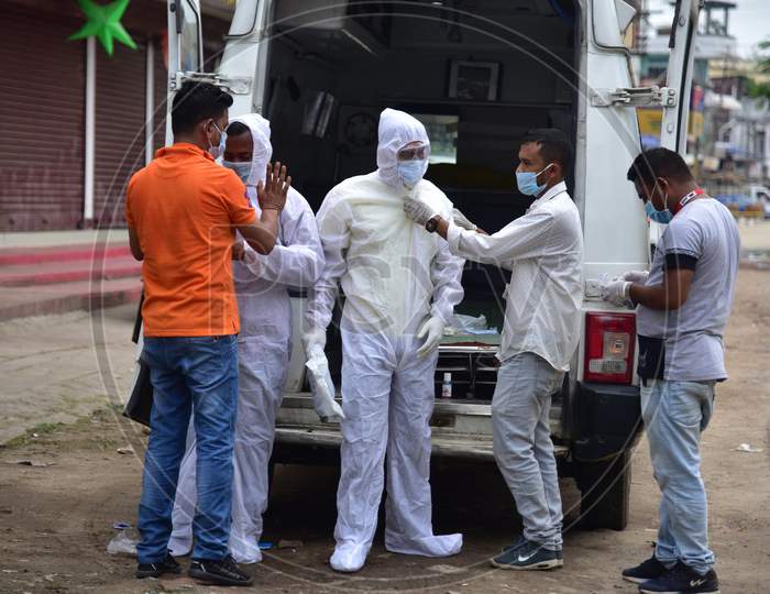 Health Workers Wear Personnel Protective Equipment Kit (Ppe) Before Heading To Bring A Covid19 Positive Patient To An Ambulance For Shifting Him To Guwahati from Nagaon
