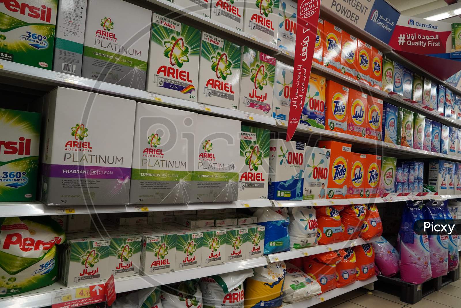 Supermarket Display With Different Brands Of Washing Powder In Boxes. Wholesale. Tide, Ariel, Omo Laundry Detergent Boxes Lined Up For Sale In A Store Shelf- Dubai Uae December 2019