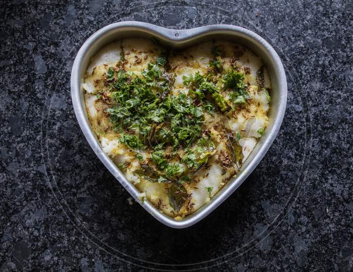Dhokla In A Heart Shaped Bowl With Gray Granite Background