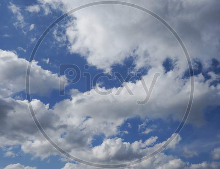White Clouds Spread All Over The Blue Sky Creating A Contrast And An Abstract Pattern
