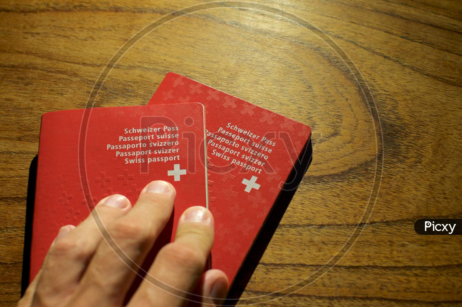 Two Swiss Passport On A Wooden Table