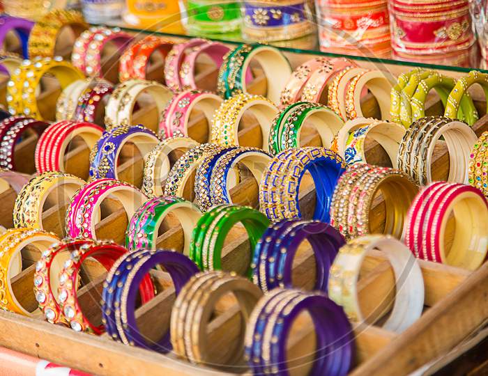 Indian Colorful Bracelets And Golden Bangles Or Armbands Displayed In Local Shop In A Market Of Pushkar, Rajasthan, India