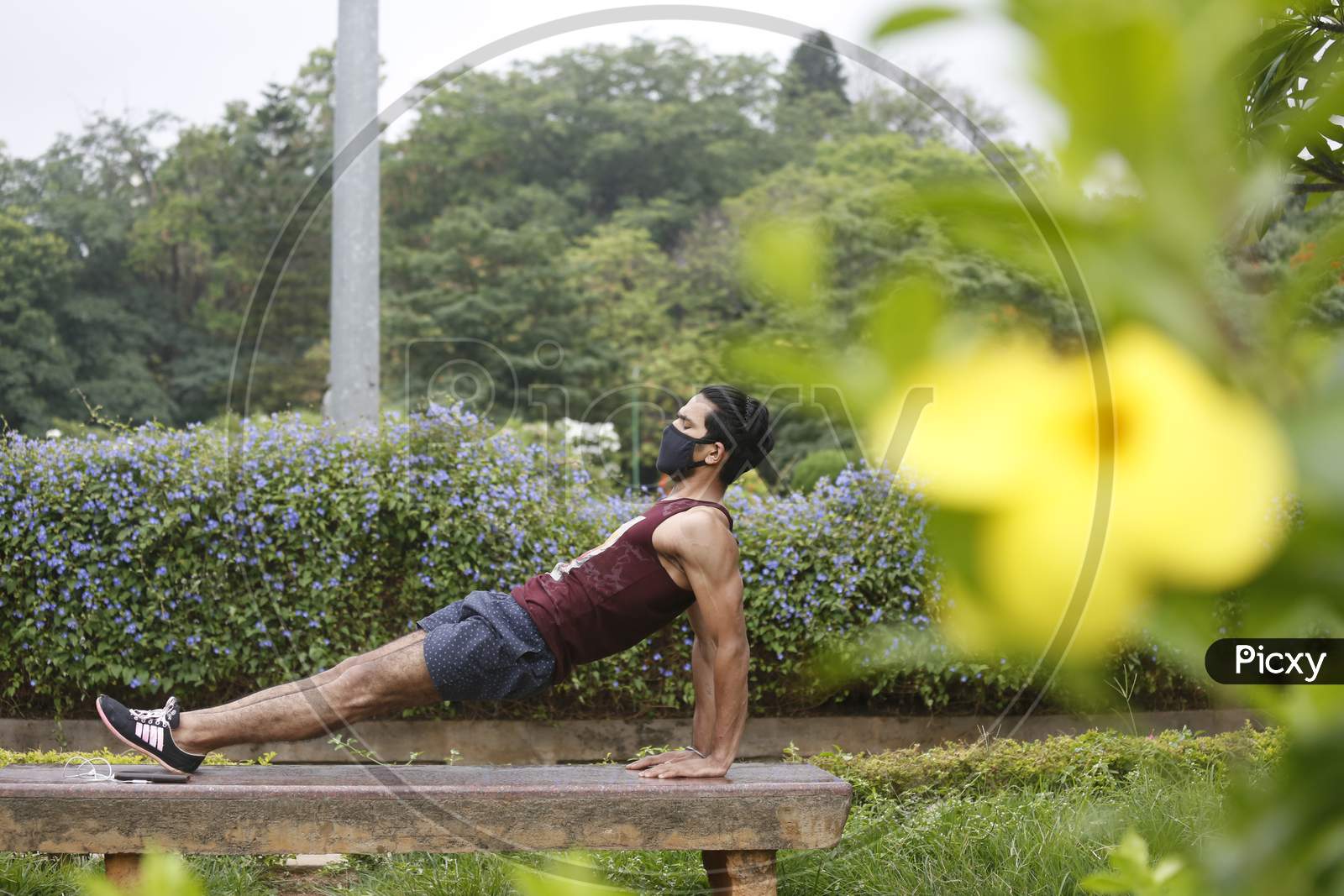 A man exercises on a park bench in Cubbon Park after the state eased lockdown norms during the nationwide lockdown to prevent the spread of coronavirus (COVID-19) in Bangalore, India.