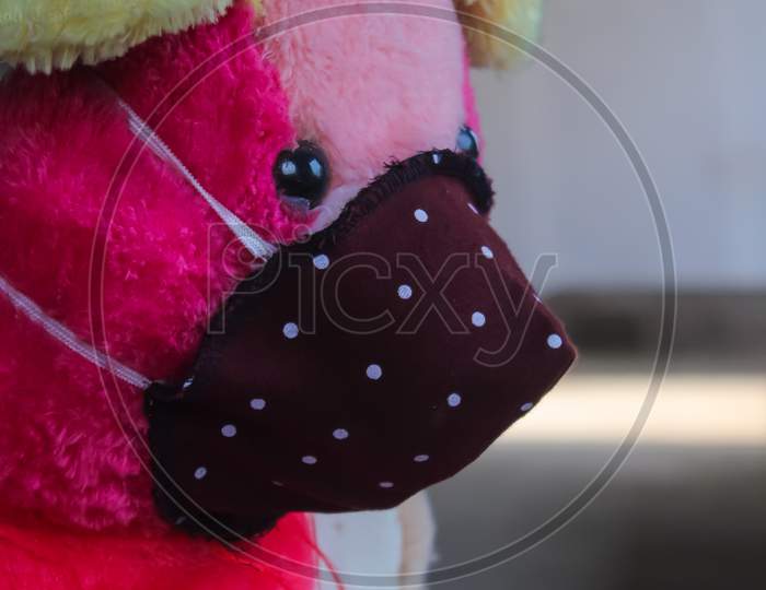 A Pink teddy bear doll wear Mask quarantine days
