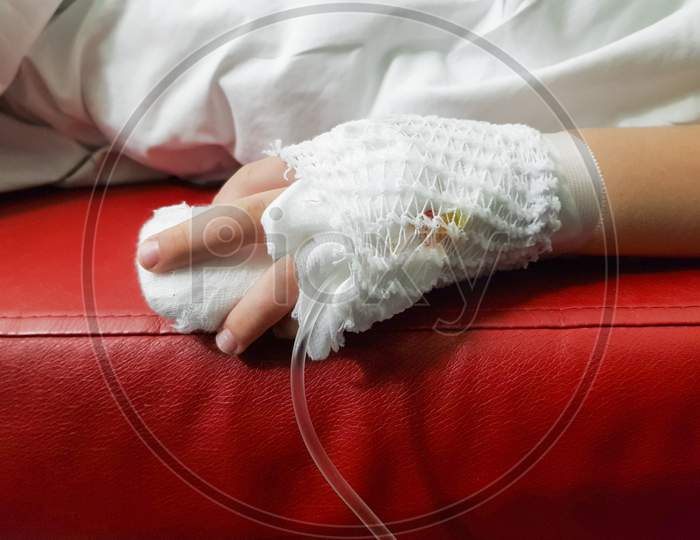 Close Up Infant Hand With Iv Drip In Hand