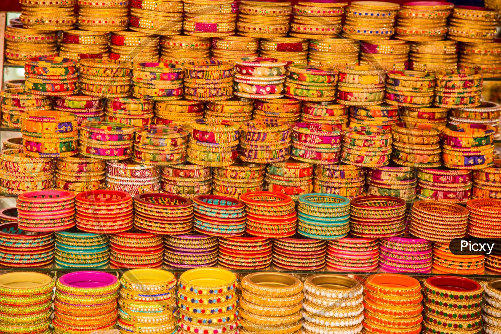 Indian Colorful Bracelets And Golden Bangles Or Armbands Displayed In Local Shop In A Market Of Pushkar, Rajasthan, India