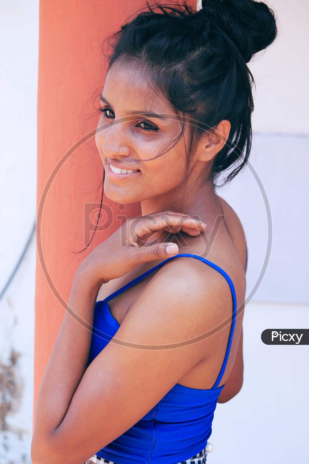 Smooth skin model posing with blue top