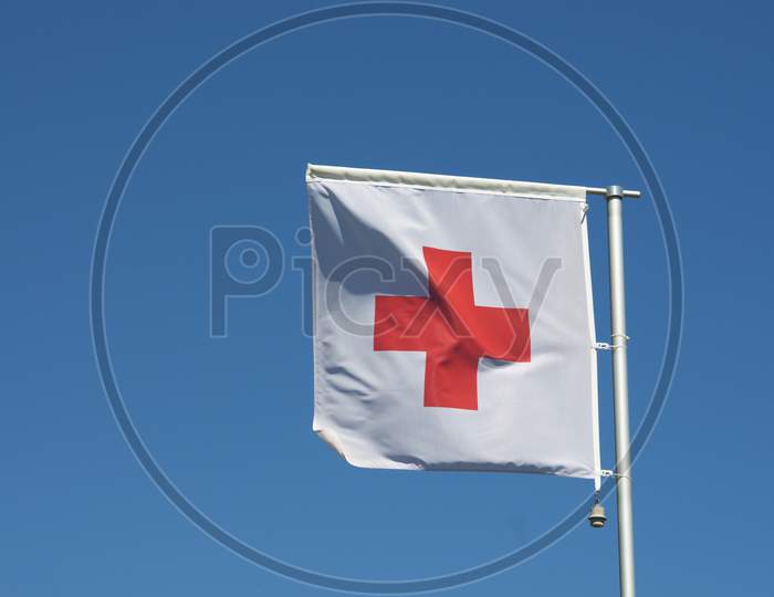 International Red Cross Flag Against Blue Sky
