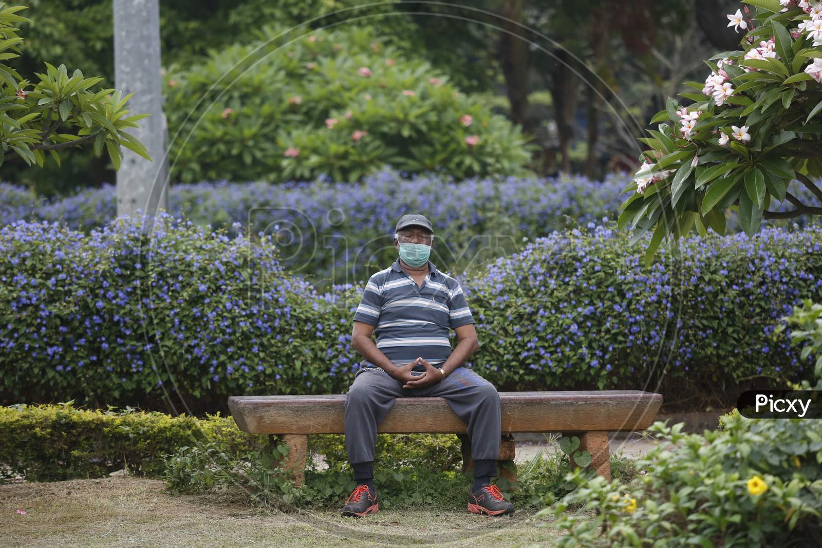A man performs breathing exercises in Cubbon Park after the state eased lockdown norms during the nationwide lockdown to prevent the spread of coronavirus (COVID-19) in Bangalore, India.