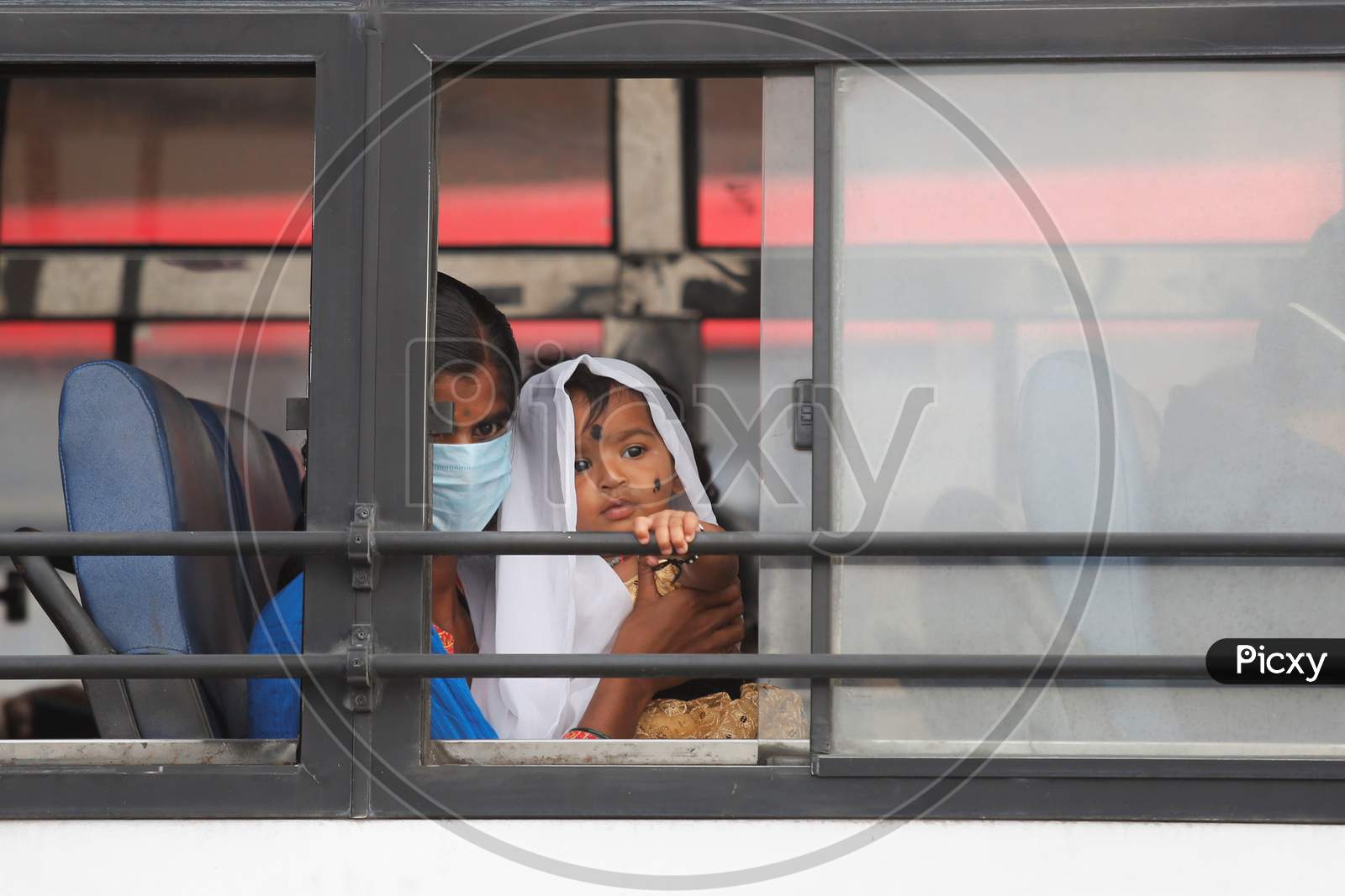 A child looks out of a public transport bus after the state eased lockdown norms during the nationwide lockdown to prevent the spread of coronavirus (COVID-19) in Bangalore, India.