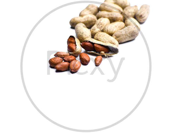 Close up view of shelled peanuts and cracked peanuts isolated on white background